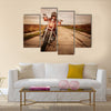 Biker girl in a leather jacket and helmet on a motorcycle Multi panel canvas wall art