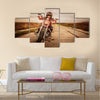 Biker girl in a leather jacket and helmet on a motorcycle Multi panel canvas wall art