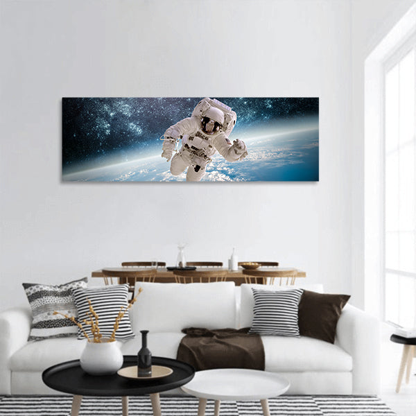Astronaut in outer space image furnished by NASA panoramic canvas wall art