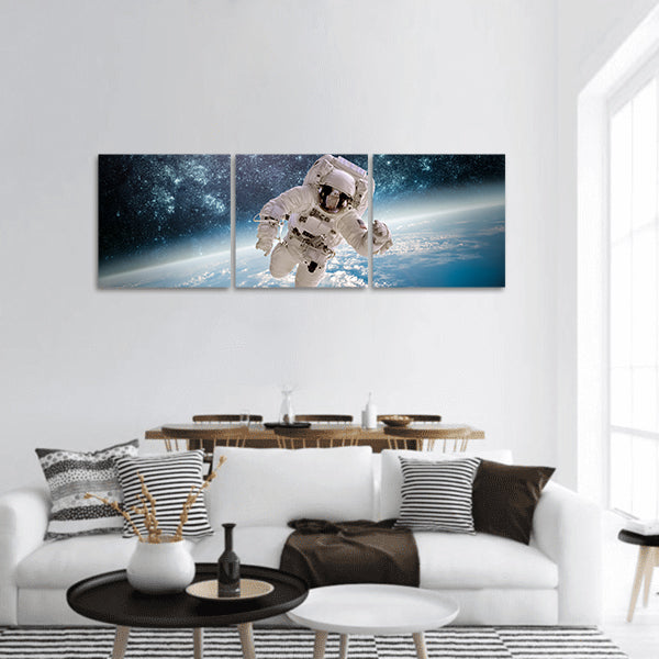 Astronaut in outer space image furnished by NASA panoramic canvas wall art