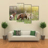 Herd of Alpine Goats Grazing on Meadow and Looking at Camera Multi Panel Canvas Wall Art