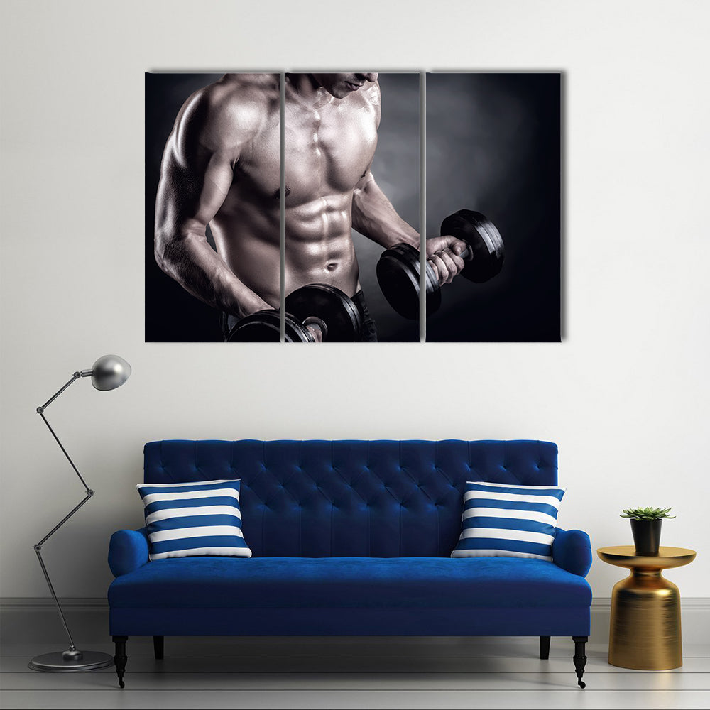 Close up of a muscular young man lifting weights on dark background, Multi panel canvas wall art