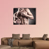 Healthy muscular young man on a dark background Multi panel canvas wall art