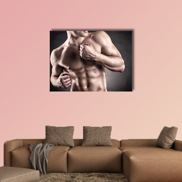 Healthy muscular young man on a dark background Multi panel canvas wall art