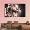 Healthy muscular young man on a dark background Multi panel canvas wall art