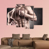 Healthy muscular young man on a dark background Multi panel canvas wall art