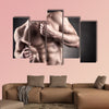 Healthy muscular young man on a dark background Multi panel canvas wall art