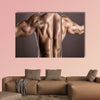 strong athletic man back on a gray background Multi panel canvas wall art