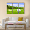 Golf ball on course with beautiful blurry landscape Multi Panel Canvas Wall Art