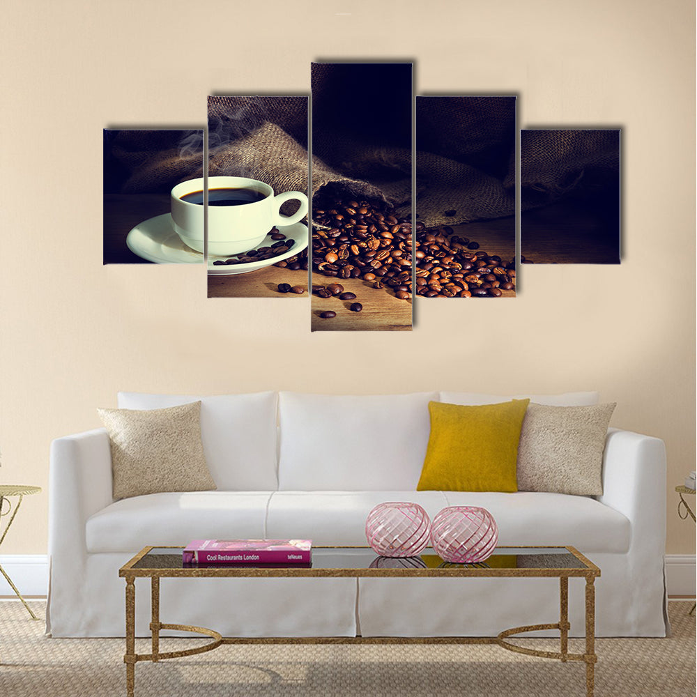Coffee cup and coffee beans on a wooden table Multi Panel Canvas Wall Art