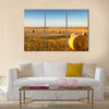 Freshly cropped, farm land hay bales on a sunset Multi panel canvas wall art