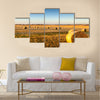 Freshly cropped, farm land hay bales on a sunset Multi panel canvas wall art