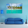 Tourist arriving beautiful beach with crystal clear turquoise water multi panel canvas wall art