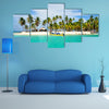 Tourist arriving beautiful beach with crystal clear turquoise water multi panel canvas wall art