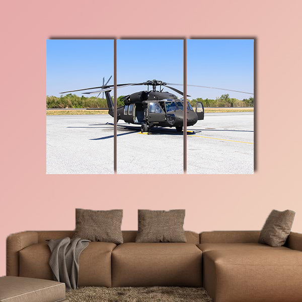Military helicopter Blackhawk at a base multi panel canvas wall