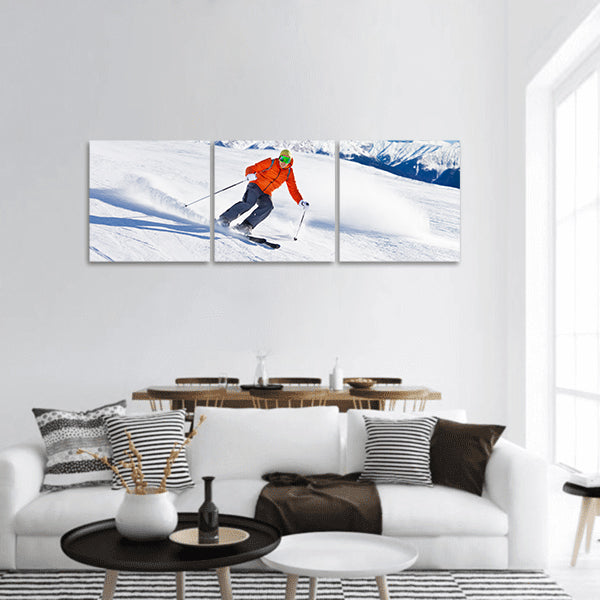 Skier in mask slides fast while skiing from slope panoramic canvas wall art