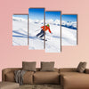 Skier in mask slides fast while skiing from slope Multi panel canvas wall art