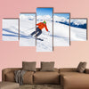 Skier in mask slides fast while skiing from slope Multi panel canvas wall art