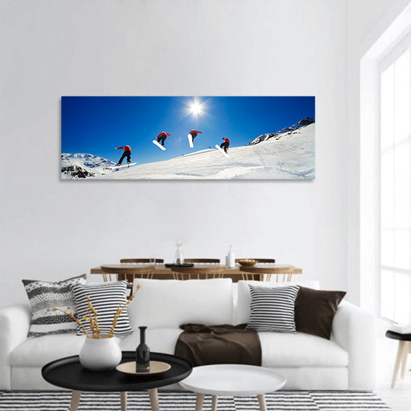 Sequence shot of snowboarder going over jump panoramic canvas wall art