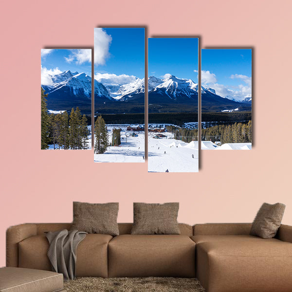 Skiers and snowboarders descend the slopes toward Lake Louise art