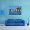 Tropical cabins over water of the Caribbean Sea, multi panel canvas wall art