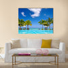 Tropical beach resort with lounge chairs and umbrellas in Mauritius Multi panel canvas wall art