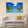 Tropical beach resort with lounge chairs and umbrellas in Mauritius Multi panel canvas wall art