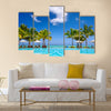 Tropical beach resort with lounge chairs and umbrellas in Mauritius Multi panel canvas wall art