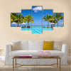 Tropical beach resort with lounge chairs and umbrellas in Mauritius Multi panel canvas wall art