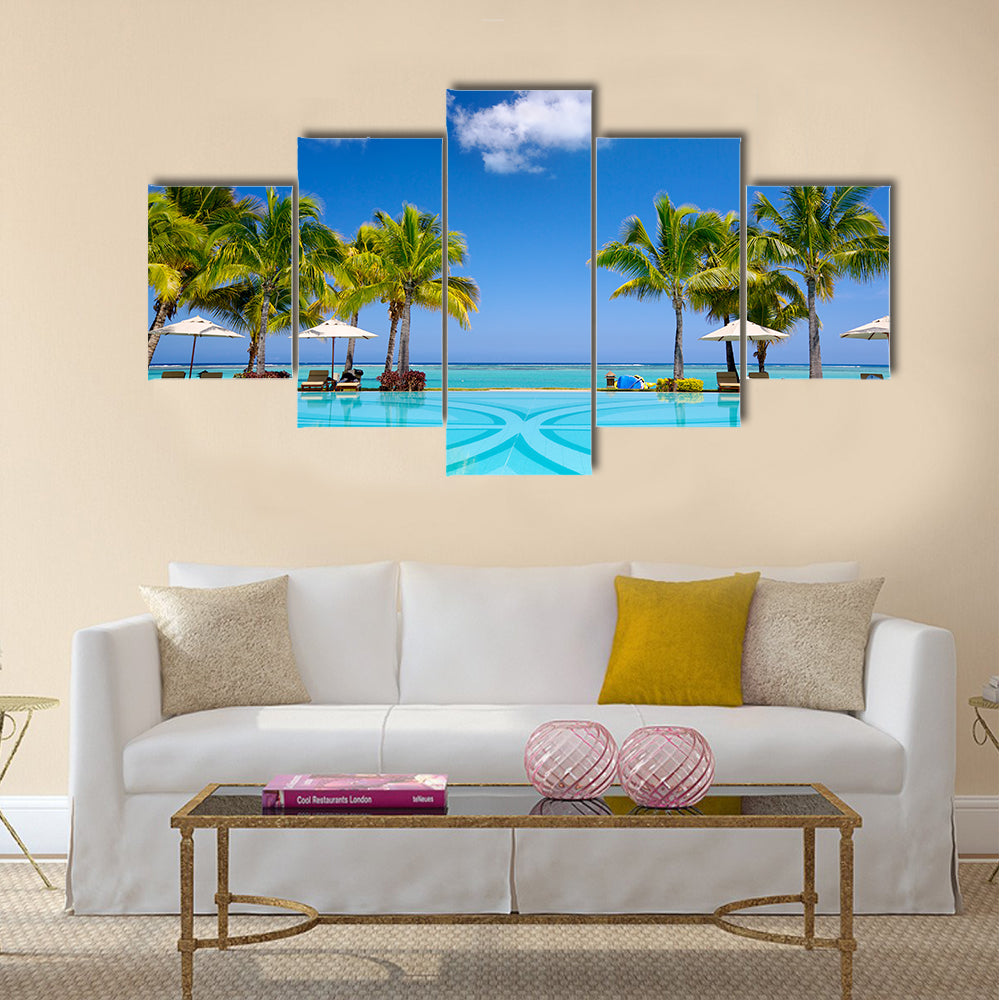 Tropical beach resort with lounge chairs and umbrellas in Mauritius Multi panel canvas wall art