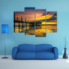 An old floating restaurant view in sunset multi panel canvas wall art