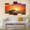 Marine life background - jumping dolphins, beautiful red sunset on sea multi panel canvas wall art