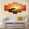 Marine life background - jumping dolphins, beautiful red sunset on sea multi panel canvas wall art