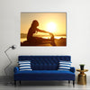 Silhouette of a fitness woman stretching at sunset with the sun in the background, Multi panel canvas wall art