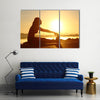 Silhouette of a fitness woman stretching at sunset with the sun in the background, Multi panel canvas wall art