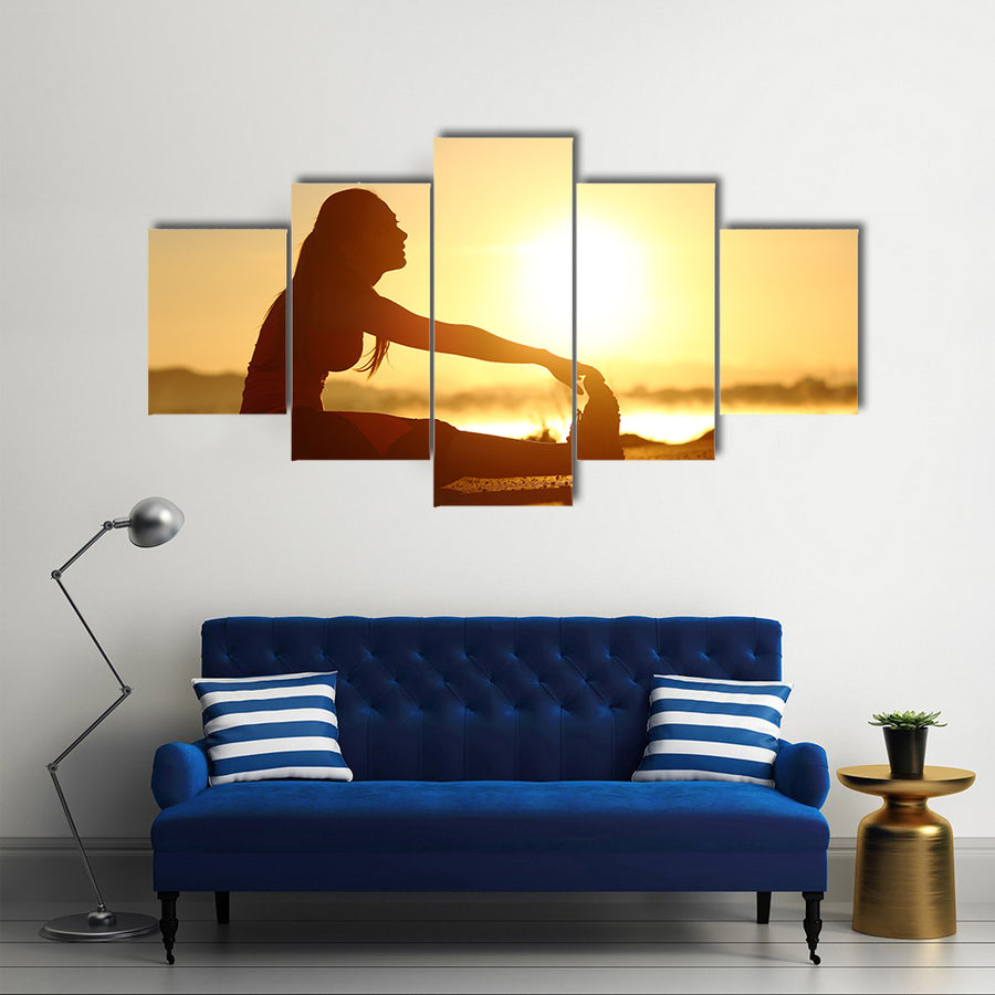 Silhouette of a fitness woman stretching at sunset with the sun in the background, Multi panel canvas wall art