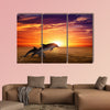 Marine life background - jumping dolphins, beautiful red sunset on sea Multi panel canvas wall art