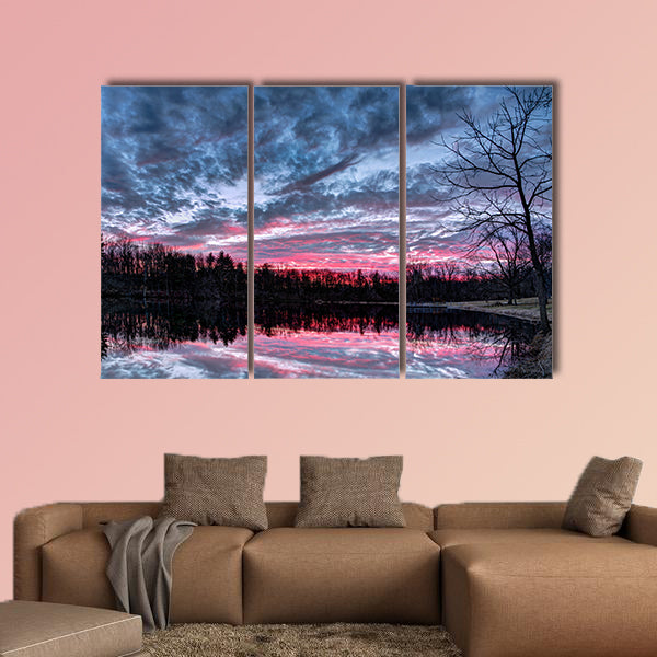 The setting sun paints the sky with dramatic colors that is reflected on a small Indiana pond Multi panel canvas wall art