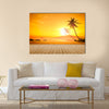 A beautiful sunset over the ocean with a palm tree and wooden jetty foreground Multi panel canvas wall art