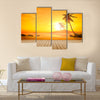 A beautiful sunset over the ocean with a palm tree and wooden jetty foreground Multi panel canvas wall art