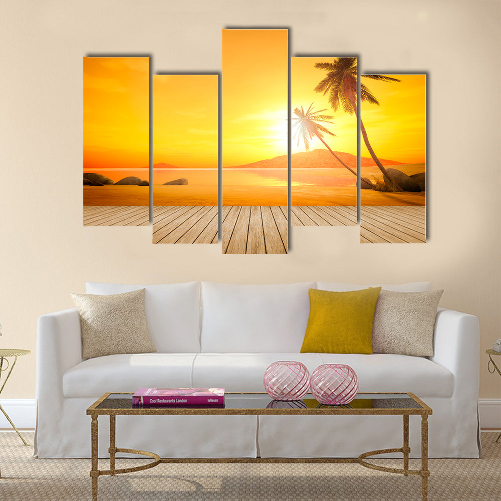 A beautiful sunset over the ocean with a palm tree and wooden jetty foreground Multi panel canvas wall art