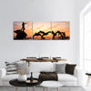 Statues of Dolphins in fountain orange sunset over ocean panoramic canvas wall art