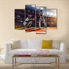 Soccer player in action on night stadium background panorama Multi Panel Canvas Art