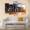 Soccer player in action on night stadium background panorama Multi Panel Canvas Art