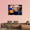 Bodybuilding couple against dark room Multi panel canvas wall art