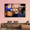 Bodybuilding couple against dark room Multi panel canvas wall art