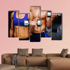 Bodybuilding couple against dark room Multi panel canvas wall art