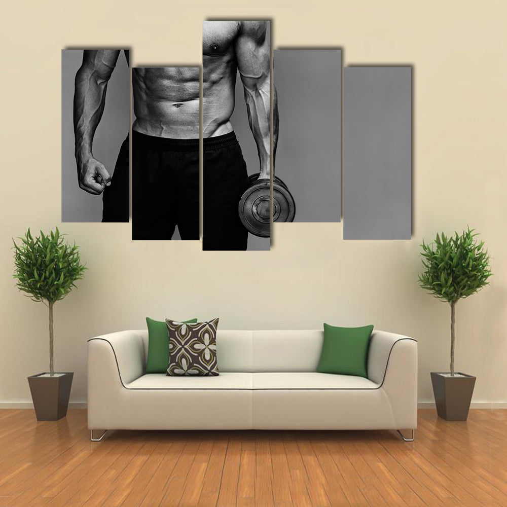 Close up of muscular bodybuilder guy doing exercises with weights over grey background