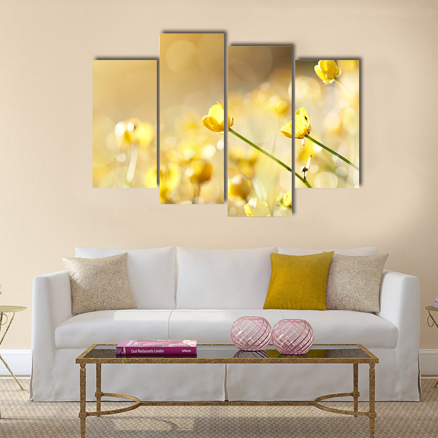 Yellow flowers of a buttercup on a meadow lit with the sun Multi Panel Canvas Wall Art