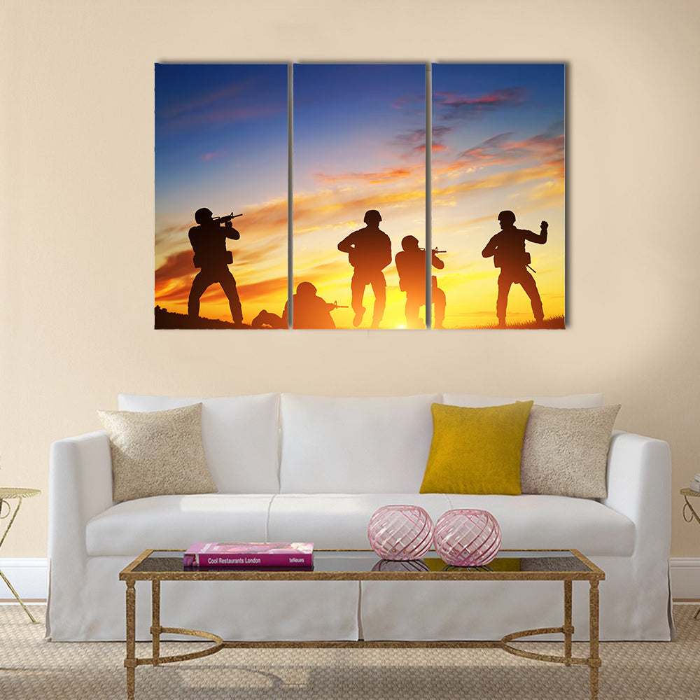 Soldiers in assault shooting with weapon, rifle at sunset. War, army, military Multi Panel Canvas Wall Art